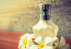 Perfume Bottle with flower alongside