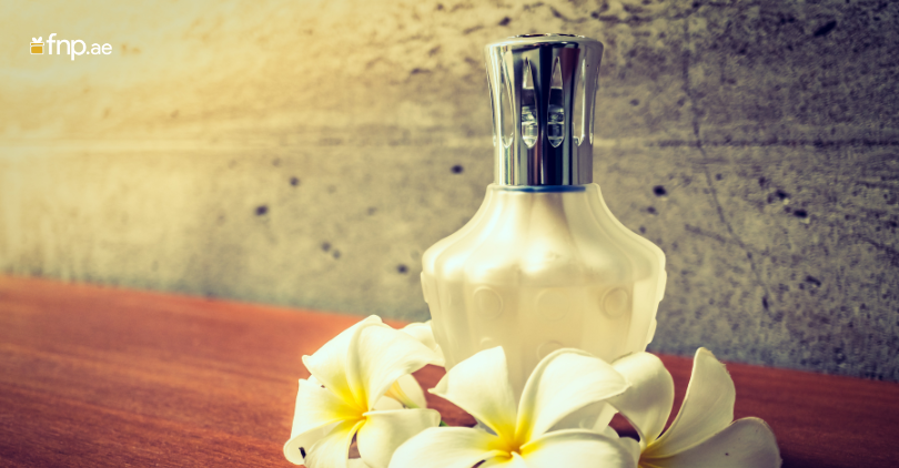 Perfume Bottle with flower alongside
