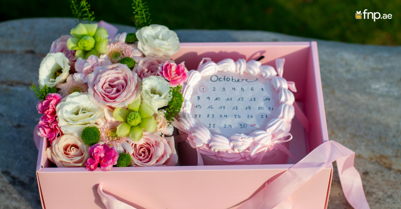 A Burn away calendar cake with beautiful flowers alongside