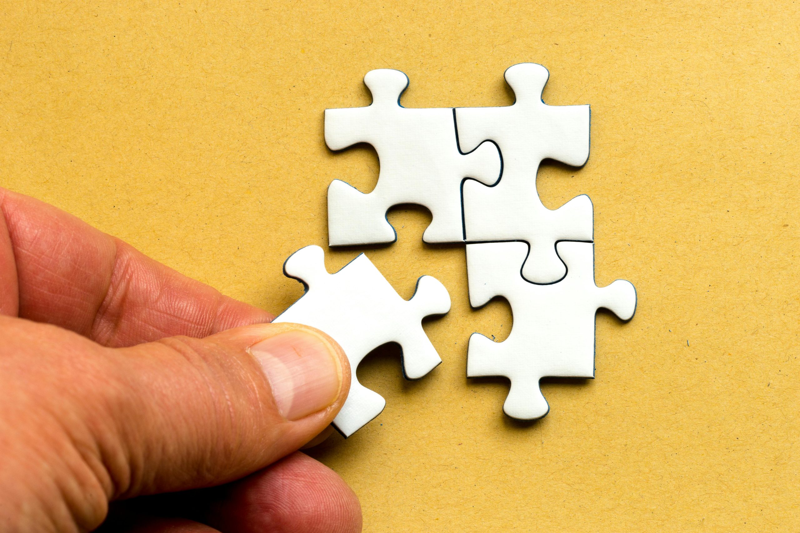 A person solving jigsaw puzzle
