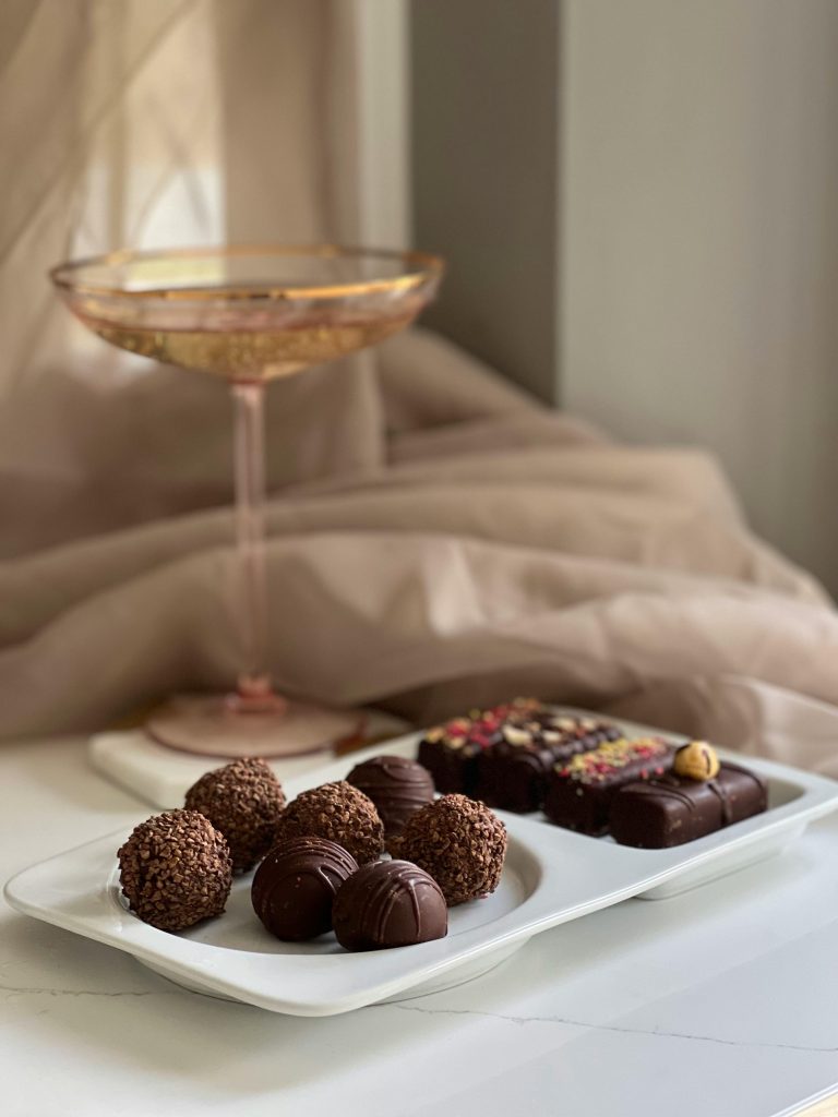 Chocolate Pieces with glass of wine alongside