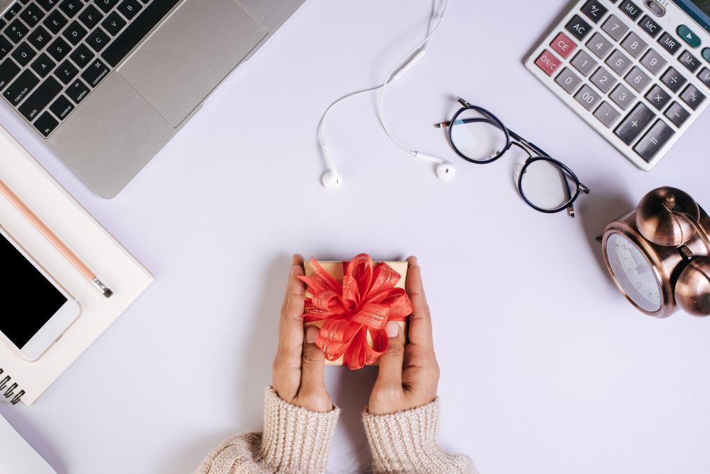 Women holding a personalised gift box with cute ribbon