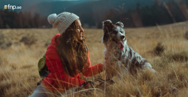 A women with her cute dog enjoying vacations