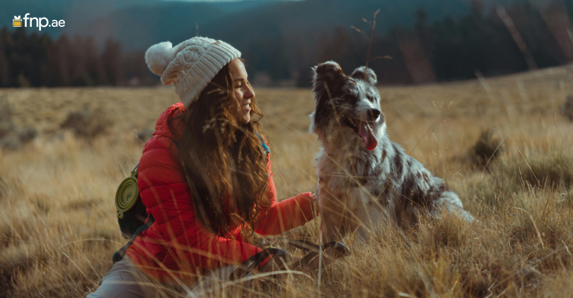 A women with her cute dog enjoying vacations