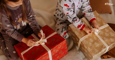 Young girl unwrapping her birthday gifts