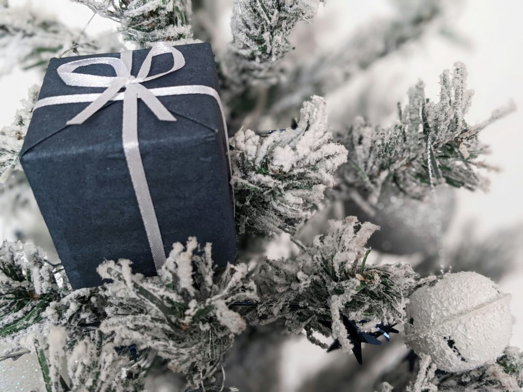 A gift box wrapped in white ribbon