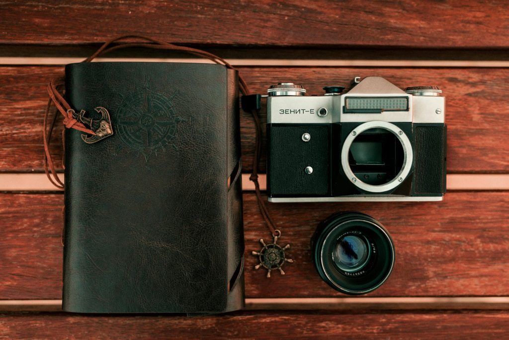 Journal with travel photography camera alongside