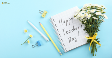 Happy Teacher's Day written on notebook with flower Bouquet alongside