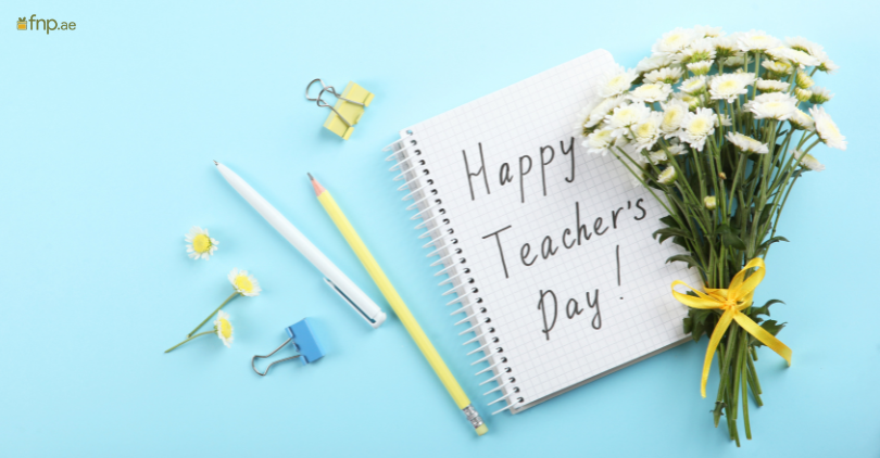 Happy Teacher's Day written on notebook with flower Bouquet alongside