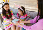Mother of 2 girls giving them gift on daughter's day
