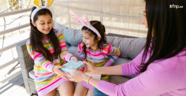Mother of 2 girls giving them gift on daughter's day