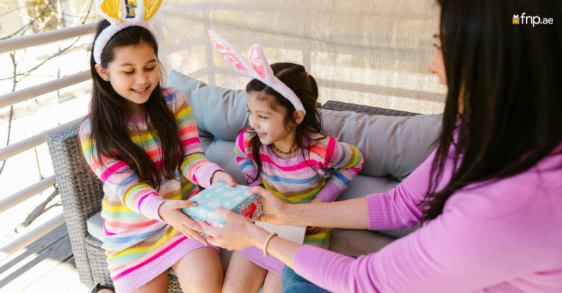 Mother of 2 girls giving them gift on daughter's day
