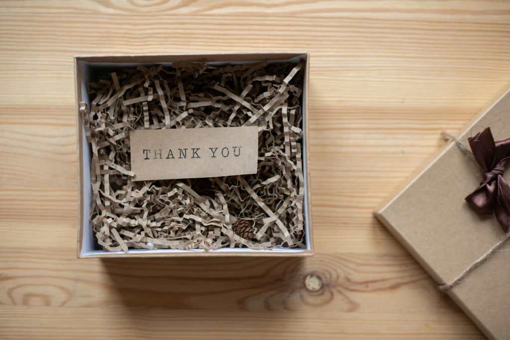 A gift Box with Thank you note placed in it.