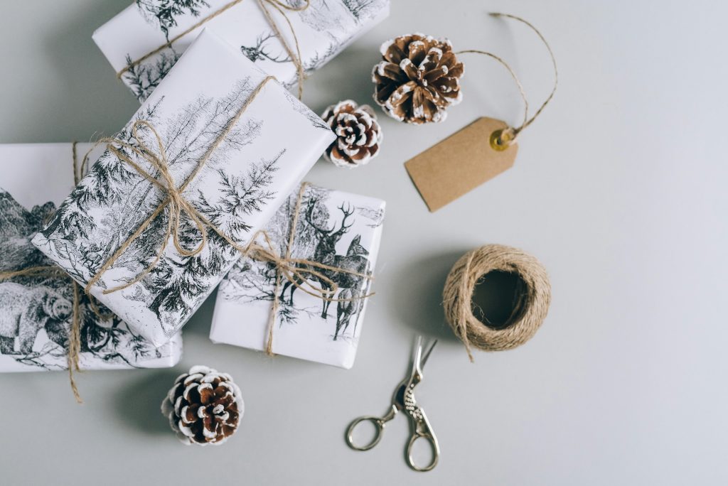 Gifts wrapped in beautiful printed white paper tied with thread
