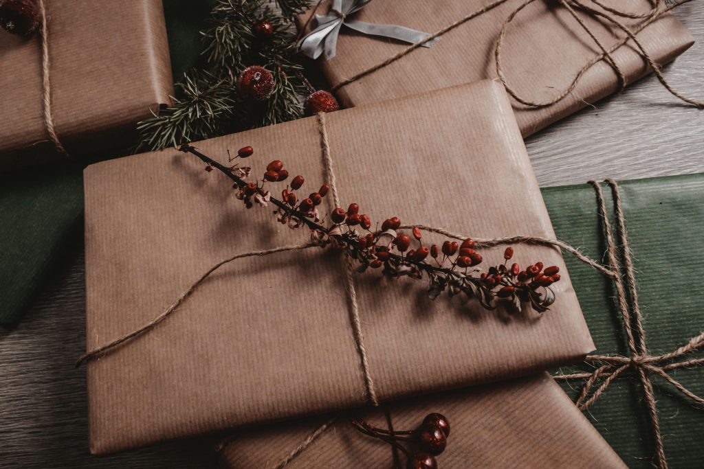 Gift box wrapped with paper and tied with thread and flower