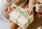 A women Unwrapping gift on her lap