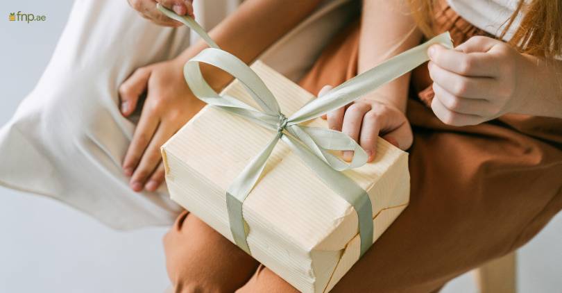 A women Unwrapping gift on her lap
