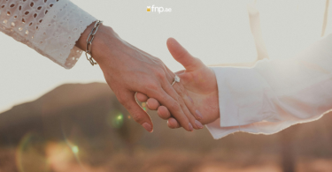 Couple holding each other's hands while proposing