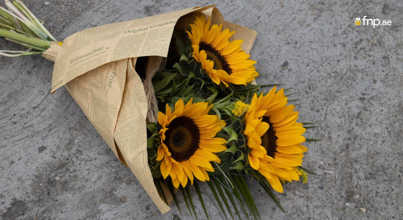 Beautiful 3 Sunflower Bouquet wrapped in newspaper and ties with ribbon
