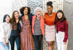 Women from different backgrounds standing Together in office