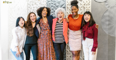 Women from different backgrounds standing Together in office