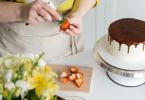 A Woman making strawberry Topping for her delicious Cake