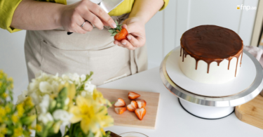 A Woman making strawberry Topping for her delicious Cake