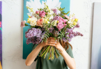 Person holding beautiful flower bouquet in their hand as a sorry gesture