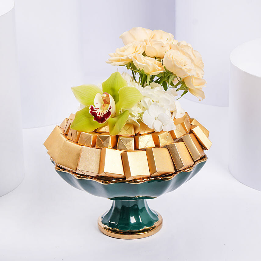 assorted chocolates with peach roses beautifully presented in bowl